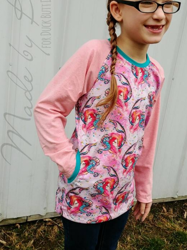 Young, white, girl is wearing black rimmed glasses, is smiling with missing fron