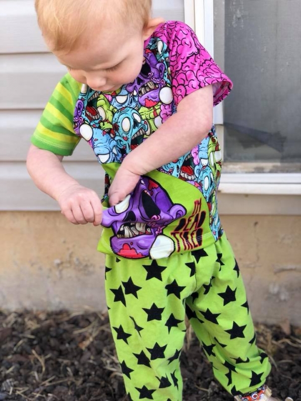 Shown is a young girl, around two. She has a look of hard concentration on her f